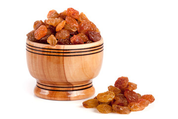 raisins in a wooden bowl isolated on white background