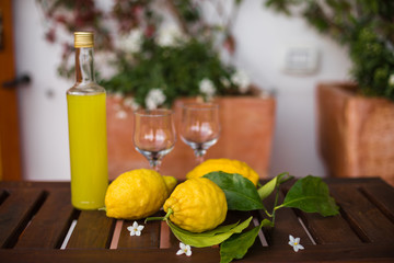 Bottle and glasses of fresh lemonade on table.