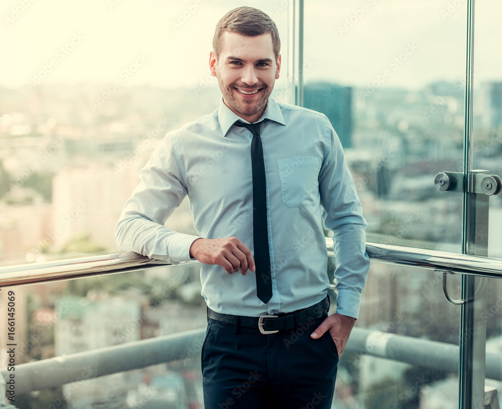 Wall mural Handsome businessman outdoors