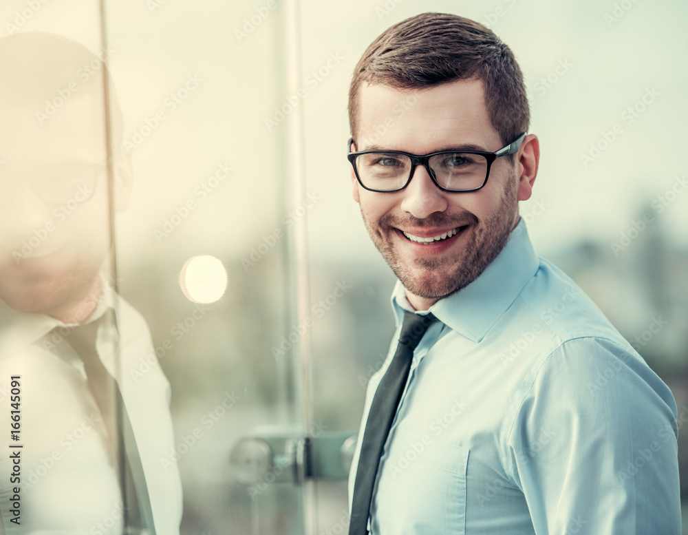 Wall mural Handsome businessman outdoors