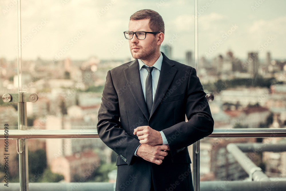 Wall mural Handsome businessman outdoors