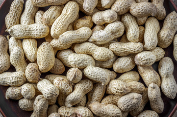 Dried peanuts in shell on wooden table. Top view