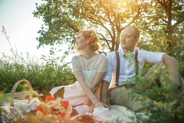 Attractive Couple Enjoying Romantic Sunset Picnic in the Countryside