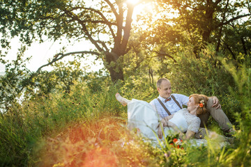 Attractive Couple Enjoying Romantic Sunset Picnic in the Countryside