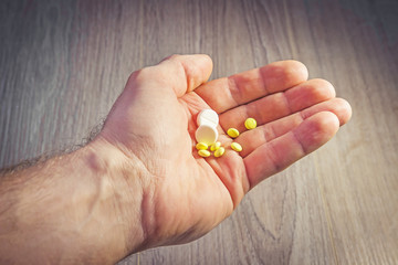 Pills in man's hand close-up. Health and medicine. Pharmaceuticals. Take pills, treatment.