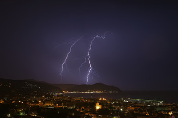 Obraz na płótnie Canvas Lightning and thunderstorm on the Tigullio Gulf - Ligurian sea - Chiavari - Italy