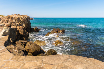 Fototapeta na wymiar Rocky coast and turquoise sea water at Naxos island. Greece.