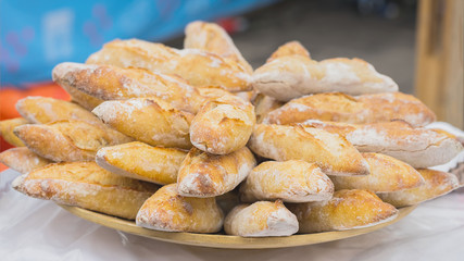 Close-up of fresh bread, hot organic baguettes for sandwiches in market, selective focus.