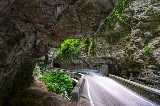 Single road leading through a deep Canyon in northern Italy