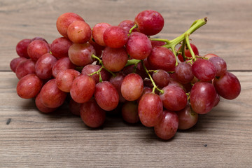 Cluster of grapes on top of a wooden table