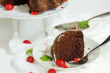 Slice of Chocolate Bundt cake served in a  floral dessert plate