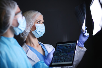 Medical team speaking of a X-ray in an operating room. Doctor. X-ray