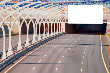 Tunnel on highway with blank billboard over it