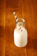 Vintage style glass milk bottle with paper straw