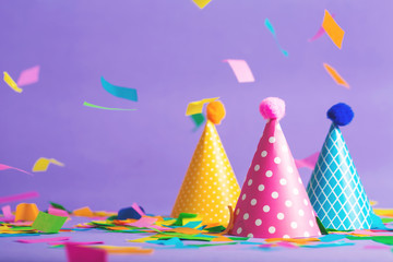 Party hat celebration theme with confetti on a bright background - obrazy, fototapety, plakaty