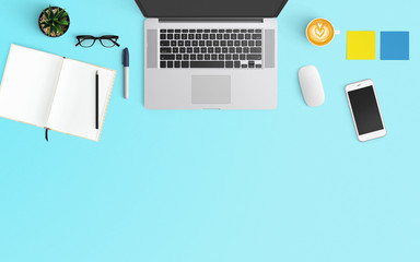 Modern workspace with coffee cup, notebook, smartphone and laptop copy space on Blue color...