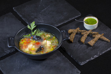 Seafood soup. Soup from salmon, pike perch, shrimp, octopus and mussels with croutons