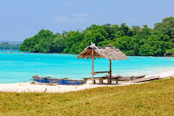 Outrigger canoes and a leaf beach bungalow at Olry Bay - Espiritu Santo, Vanuatu