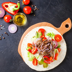 Tacos with Vegetables and Meat against a dark Background. Selective Focus. Top View. Copy Space