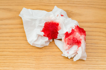 bloody tissue on a wood table