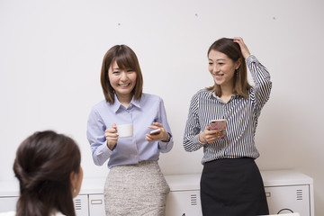 Three women are chatting in a rest room