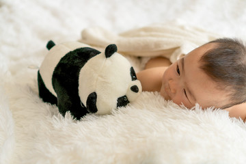 
baby with panda toy