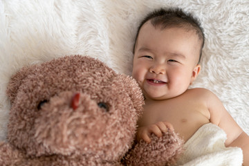 baby with bear toy