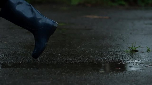Closeup - Girl in Blue Rubber Boots And Black Legency Kicking a Tin Can From Beer, in Rainy Weather, Stop Alcoholism