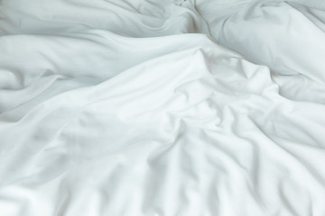 Top view of white bedding sheets after wake up in the morning