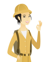 Young asian traveler showing ok sign.