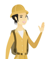 Young asian traveler waving her hand.