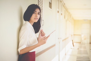 Asian women businessmen use tablet to contact work and business.