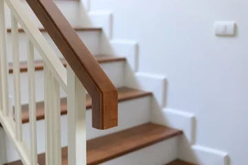 Fotobehang Trappen wood banister on staircase interior
