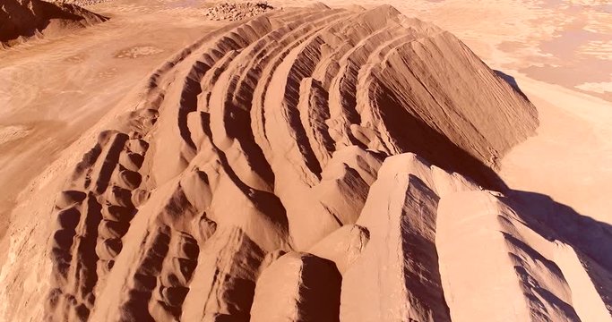 Gravel quarry looks like strange alien landscape, aerial flyover.
