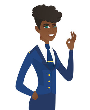 Young african-american stewardess showing ok sign.