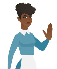 Young african-american cleaner showing palm hand.