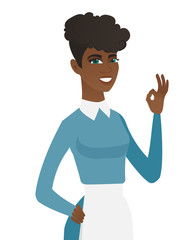 Young african-american cleaner showing ok sign.