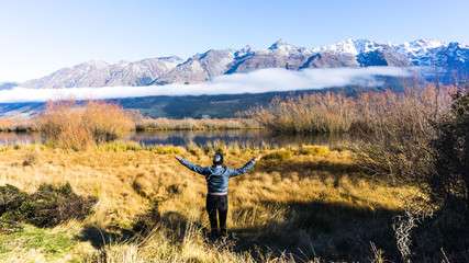 Fototapeta na wymiar Girl standing in front of mountains