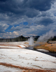 Iron Spring Creek flowing past Cliff Geyser in Black Sand Geyser Basin in Yellowstone National Park...
