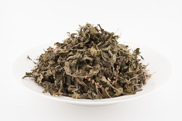 Organic dry Green or Holy Basil (Ocimum tenuiflorum) leaves on white background ,holy basil herb used in natural alternative herbal medicine