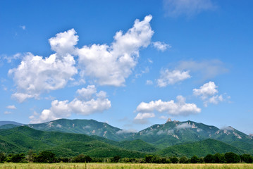 Mountains, clouds and meadow