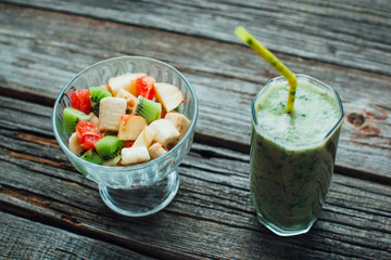 fresh fruit salad in a bowl and smoothies