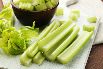 Celery on white cutting board