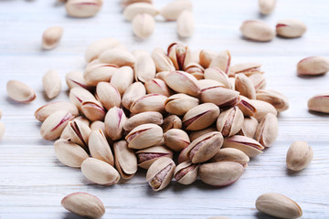 Pistachios on white wooden table