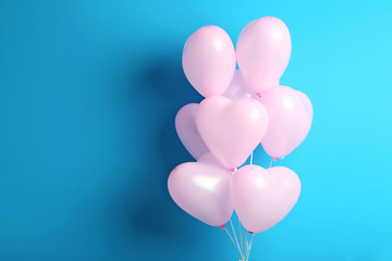 Pink heart balloons on blue background
