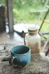 Hot Coffee cup on the wooden table in cafe natural light, vintage tone hipster style with copy space concept.