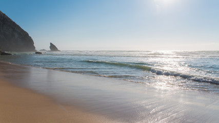 Fototapeta na wymiar Portugal, beach, beautiful seascape in the evening, sunset with sea spray 