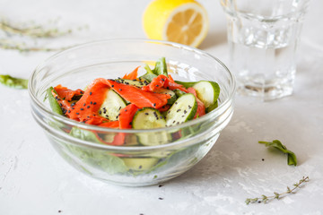 Green salad with spinach, vegetables and salted salmon