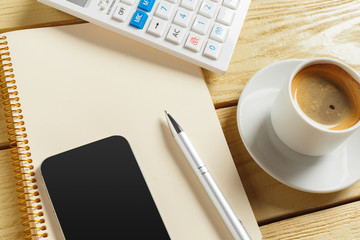 top view. coffee cup with coffee. pen putting on blank notebook.