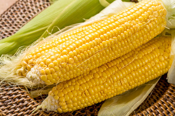 Fresh corn on rustic wooden table, closeup